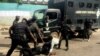 FILE - Police officers pull a journalist during an anti-government protest in Lagos, August 5, 2019. 
