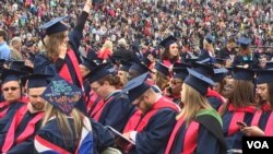 Some of the six thousand Liberty University graduates are seen in the school's football stadium for the Christian university's 44th commencement, in Lynchburg, Virginia, May 13, 2017. President Donald Trump will be speaking at the event. (C. Presutti/VOA)