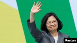 FILE - Taiwan's former President Tsai Ing-wen waves during the inauguration of new President Lai Ching-te and new Vice President Hsiao Bi-khim, outside the Presidential office building in Taipei, May 20, 2024.