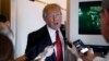 President Donald Trump speaks with reporters on Air Force One while in flight from Andrews Air Force Base, Md., to Palm Beach International Airport, Florida, April 6, 2017. 