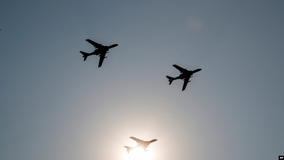 China's H-6 bomber jets fly in formation past the sun during a parade to commemorate the 70th anniversary of the founding of Communist China in Beijing, Tuesday, Oct. 1, 2019. China's Communist Party is celebrating its 70th anniversary in power with…