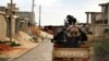 A man loyal to the Libyan armed forces prepares himself for clashes with Islamic State group militants west of Benghazi, March 7, 2016.