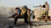 Iraqi security forces defend their positions against an Islamic State group attack in Husaybah, Iraq, June 15, 2015. 