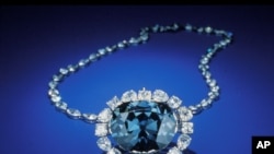 In this photo from the Smithsonian Institution,The Hope Diamond is seen in Washington. The famed diamond glows a mysterious red when exposed to ultraviolet light, a finding that scientists say can help them "fingerprint" diamonds and tell the real ones fr