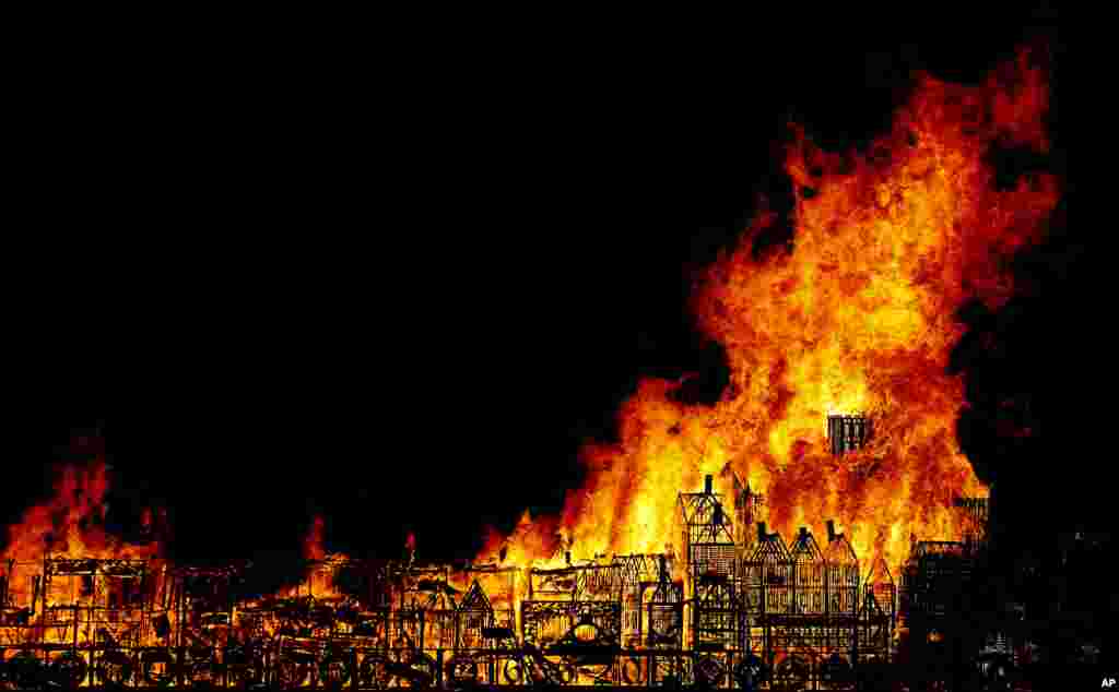 A 120-meter long sculpture of the 17th-century London skyline is set alight in a retelling of the story of the Great Fire of London in 1666, Sept. 4, 2016.