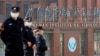 FILE - Security personnel keep watch outside the Wuhan Institute of Virology in Wuhan, Hubei province, China, Feb. 3, 2021.