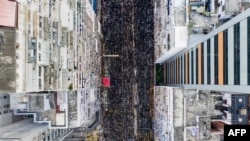 This overhead view shows thousands of protesters marching through the street as they take part in a new rally against a controversial extradition law proposal in Hong Kong on June 16, 2019. 