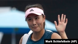 FILE - China's Peng Shuai waves after losing to Canada Eugenie Bouchard in their first round match at the Australian Open tennis championships in Melbourne, Australia on Jan. 15, 2019