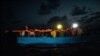 FILE - Dozens of African migrants wait to be assisted by a team of aid workers of the Spanish NGO Open Arms, after spending more than 20 hours at sea, in the Mediterranean Sea, Sept. 8, 2020.