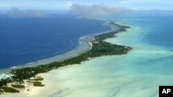 FILE - In this March 30, 2004, file photo, Tarawa atoll, Kiribati, is seen in an aerial view. Kiribati and several other small Pacific nations were among the last on the planet to have avoided any virus outbreaks, thanks to their remote locations and strict border controls.