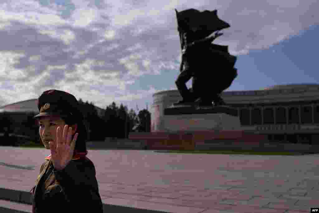 A uniformed tour guide gestures to tourists outside the War Museum in Pyongyang, North Korea. North Korea is gearing up for a lavish celebration marking the 70th anniversary of its ruling Workers&#39; Party on Oct. 10.