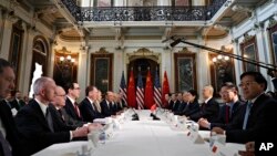 FILE - U.S. and Chinese delegations meet in the Indian Treaty Room in the Eisenhower Executive Office Building on the White House complex, during continuing meetings on the U.S.-China bilateral trade relationship, Feb. 21, 2019, in Washington. 