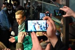 FILE - Russian opposition leader Alexei Navalny is seen at the passport control point at Moscow's Sheremetyevo airport, Jan. 17, 2021.