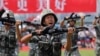 FILE - In this June 30, 2019, file photo, soldiers of Chinese People's Liberation Army demonstrate their skill during an open day of Stonecutter Island naval base, in Hong Kong. China is revising its National Defense Education Law to expand military training.