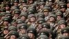 In this, April 15, 2017, photo, North Korean soldiers salute as their national anthem is played during a military parade to celebrate the 105th birth anniversary of Kim Il Sung, in Pyongyang.