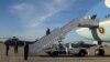 President Donald Trump disembarking from Air Force One at Joint Base Andrews, Maryland, April 9, 2017. (Photo: S. Herman / VOA)