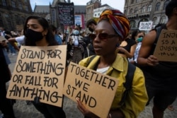 People take part in a Black Lives Matter protest in Amsterdam, Netherlands, Monday, June 1, 2020, to protest against the recent killing of George Floyd, a black man who died in police custody in Minneapolis, U.S.A., after being restrained by police…