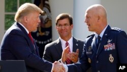 President Donald Trump, joined by Secretary of Defense Mark Esper, shakes hands with Gen. John "Jay" Raymond during a ceremony to establish the U.S. Space Command in the Rose Garden of the White House in Washington, Aug. 29, 2019.