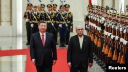 Chinese President Xi Jinping and Pakistani President Asif Ali Zardari walk past honor guards during the welcome ceremony at the Great Hall of the People in Beijing, China, Feb. 5, 2025.