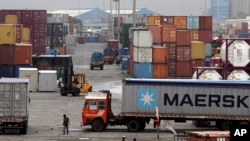 Containers are piled up at a terminal at the Jawaharlal Nehru Port Trust in Mumbai, India. 