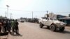 Residents watch as a U.N. Multidimensional Integrated Stabilization Mission in the Central African Republic (MINUSCA) armored personnel carrier patrols after attacks in Begoua, a northern district of Bangui, C.A.R., Jan. 13, 2021.