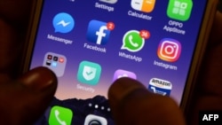 FILES - This photo taken on March 22, 2018 shows apps for WhatsApp, Facebook, Instagram and other social networks on a smartphone in Chennai.