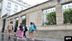 FILES - Pupils arrive at Victor-Duruy high school on the first day of new academic year in Paris, France, Sept. 4, 2023. 