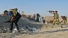 Iraqi security forces fire their weapons during clashes with Islamic State militants on the outskirts of Ramadi, June 15, 2015.