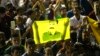 Supporters hold a flag with the image of Abdullah Ocalan, jailed leader of the Kurdistan Workers' Party (PKK) as they celebrate outside the pro-Kurdish Peoples' Democratic Party (HDP) headquarters in Diyarbakir, Turkey, June 7, 2015. 