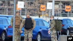 FILE - US Army officers after arrival at the Rzeszow-Jasionka airport in southeastern Poland, Feb. 5, 2022, coming from Wiesbaden, Germany where a U.S. Army administration garrison is based.
