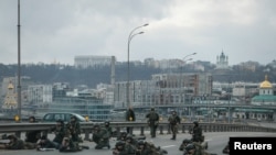 Servicemen of the Ukrainian National Guard take positions in central Kyiv, after Russia launched a massive military operation against Ukraine, Feb. 25, 2022. 