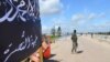 FILE - Members of al-Qaida's Nusra Front man a checkpoint in Idlib.