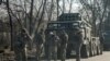Ukrainian army soldiers stand next to multiple launch missile systems, after Russian President Vladimir Putin authorised a military operation, in eastern Ukraine, in Kharkiv region, Ukraine February 24, 2022.