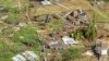 Family members survey their home, which was destroyed in the passing of Hurricane Beryl, in Ottley Hall, St. Vincent and the Grenadines, on July 2, 2024.