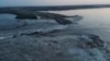 Breached dam in Ukraine's south unleashes floodwaters