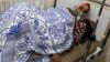 FILE - A woman, affected by what activists say was a gas attack, receives treatment inside a makeshift hospital in Kfar Zeita village in the central province of Hama May 22, 2014. 
