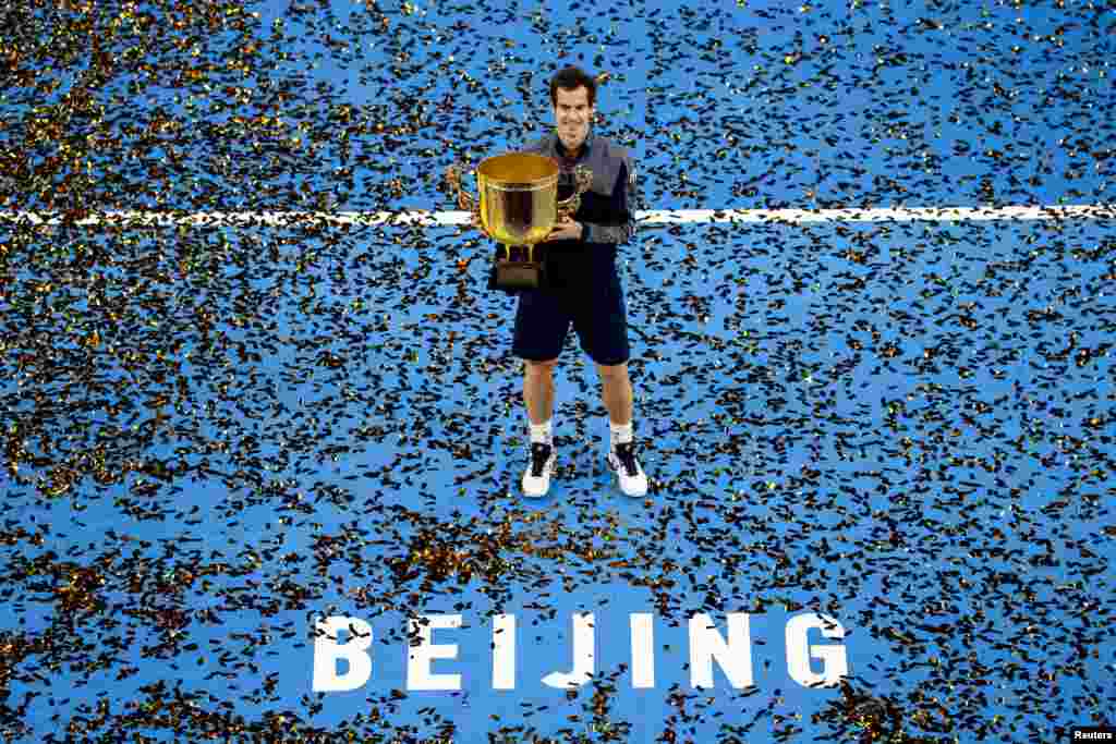 Britain's Andy Murray holds his trophy after defeating Bulgaria's Grigor Dimitrov in their men's singles final match of the China Open tennis tournament in Beijing.