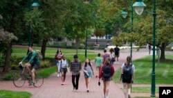 FILE - Students on the Indiana University campus, Oct. 14, 2021, in Bloomington, Ind. The State Department and the Institute of International Education report that international students in the U.S. grew by 12% in the 2022-23 academic year, the largest jump in more than 40 years.