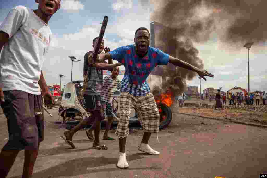 Demonstrators gather in front of a burning car during an opposition rally in Kinshasa, DRC. Police fired tear gas at scores of opposition supporters rallying in Kinshasa to demand that the country&#39;s&nbsp; long-serving President Joseph Kabila step down this year.