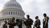 National Guard troops receive guns and ammunition outside the U.S. Capitol 