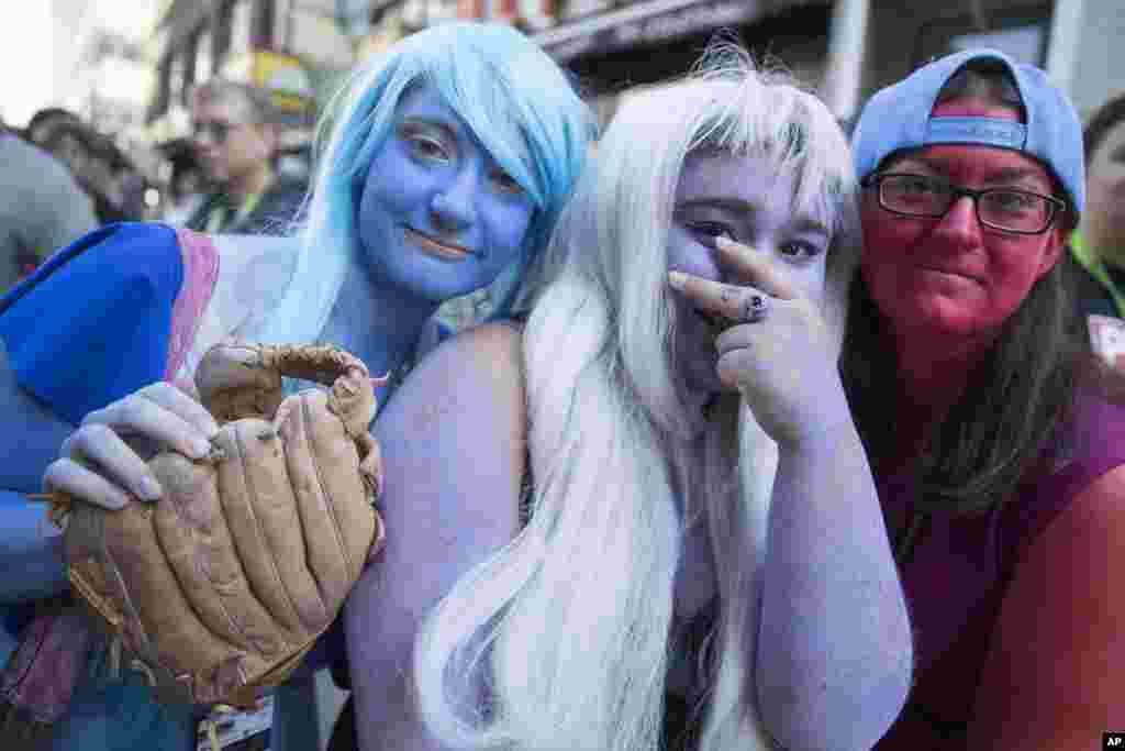Comic Con fans, dressed as Crystal Gems from "Steven Universe," pose for a photo, in New York. Comic Con runs through Oct. 9.