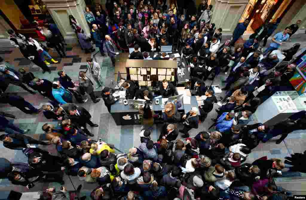 Customers gather at a store selling Apple products during the launch of the new iPhone 7 sales at the State Department Store, GUM, in central Moscow, Russia.