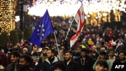 FILE - Anti-government demonstrators protest the Georgian government's postponement of European Union accession talks until 2028, outside the parliament in central Tbilisi on Dec. 31, 2024.
