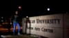 FILE - Students walk through the American University campus in Washington, December 11, 2013.