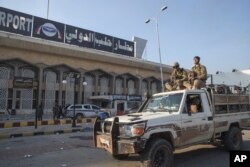 Syrian opposition fighters ride on a pick-up truck at the Aleppo international airport in Aleppo, Dec. 2, 2024.