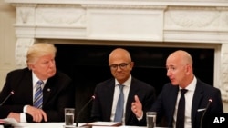 FILE - In this June 19, 2017, file photo, President Donald Trump, from left, and Satya Nadella, Chief Executive Officer of Microsoft, listen as Jeff Bezos, Chief Executive Officer of Amazon, speaks during an American Technology Council roundtable in…