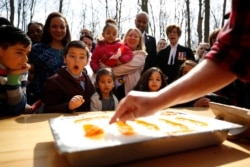 FILE - New Canadian citizen David Alfonso, 8, reacts as maple taffy is prepared for new Canadians following a citizenship ceremony at the Vanier Sugar Shack in Ottawa, Ontario, Canada, April 11, 2018.