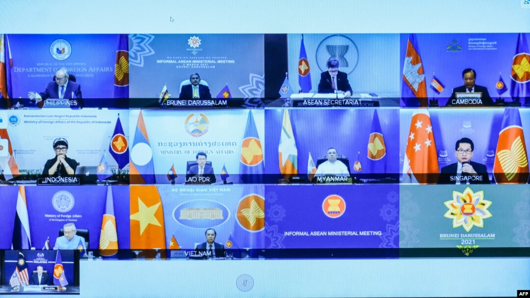This handout photo taken and released on March 2, 2021 by H2O Images shows foreign ministers and representatives of countries in the Association of Southeast Asian Nations (ASEAN) pictured on a screen during a virtual meeting in Putrajaya, outside Kuala L
