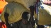 A vendor carries his bags of clothing for several blocks to his market stall, instead of using a tap tap bus due to a fuel shortage, in Port-au-Prince, Haiti, Nov. 11, 2021. 