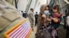 FILE - Afghan refugees board a bus taking them to a processing center upon their arrival at Dulles International Airport in Dulles, Virginia, Sept. 1, 2021. 